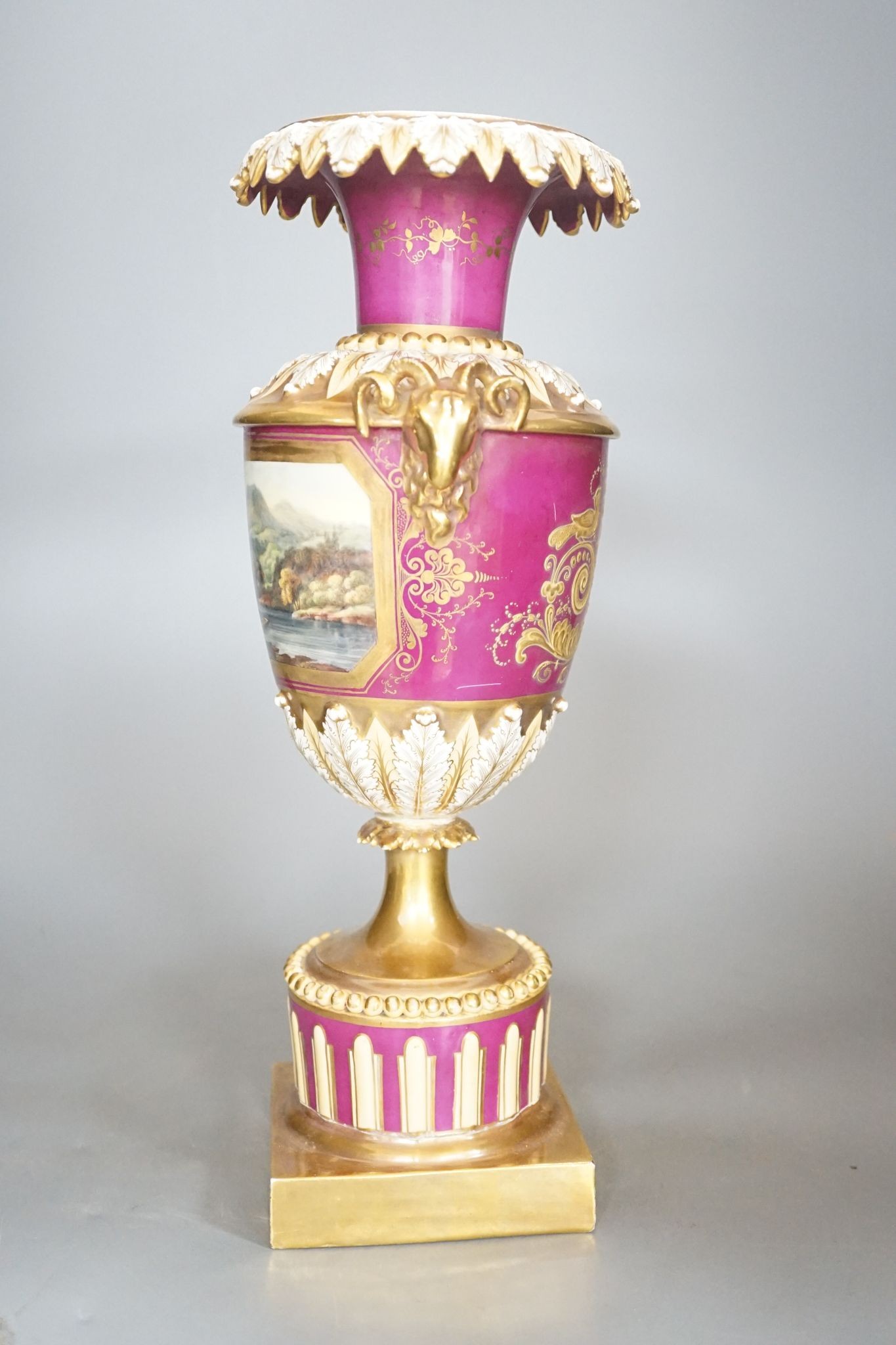A 19th century English porcelain vase painted with a landscape on crimson ground, Worcester? 35cm